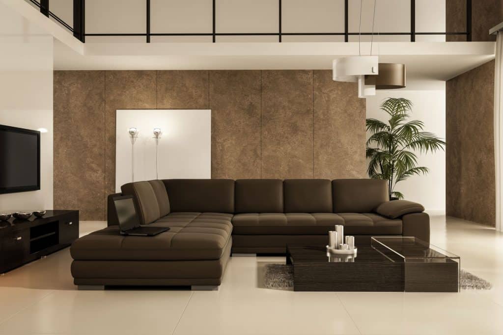 Modern living room with brown walls, brown couches and white painted second floor