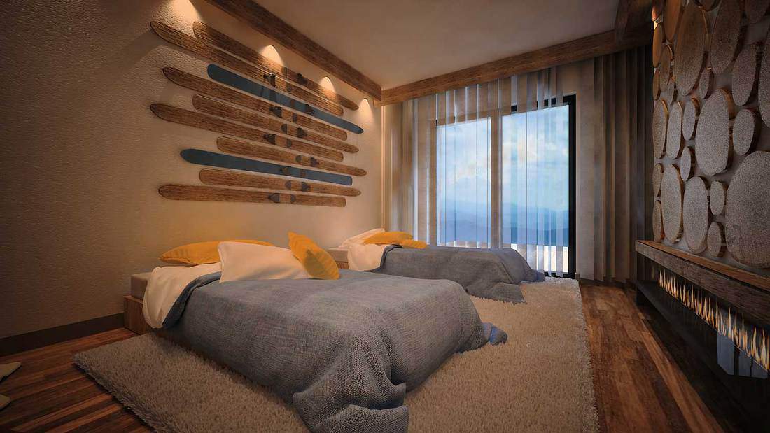 Mountain cabin bedroom with two single beds and skis decoration mounted on wall