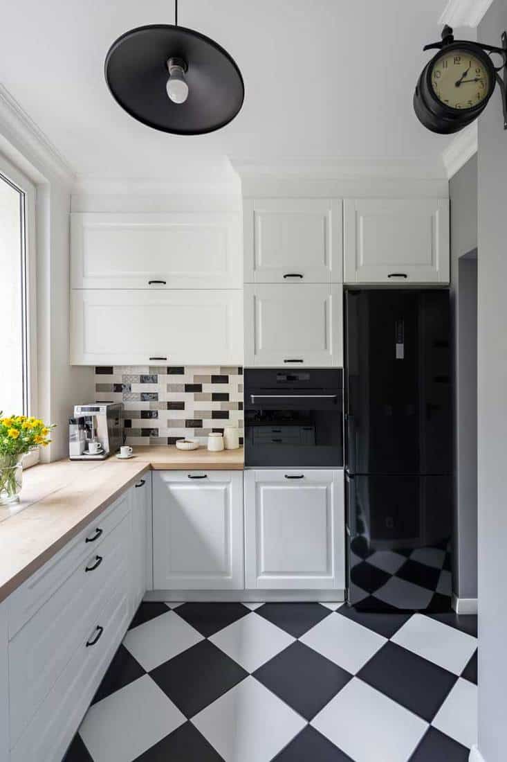 Small, white kitchen with modern chess flooring