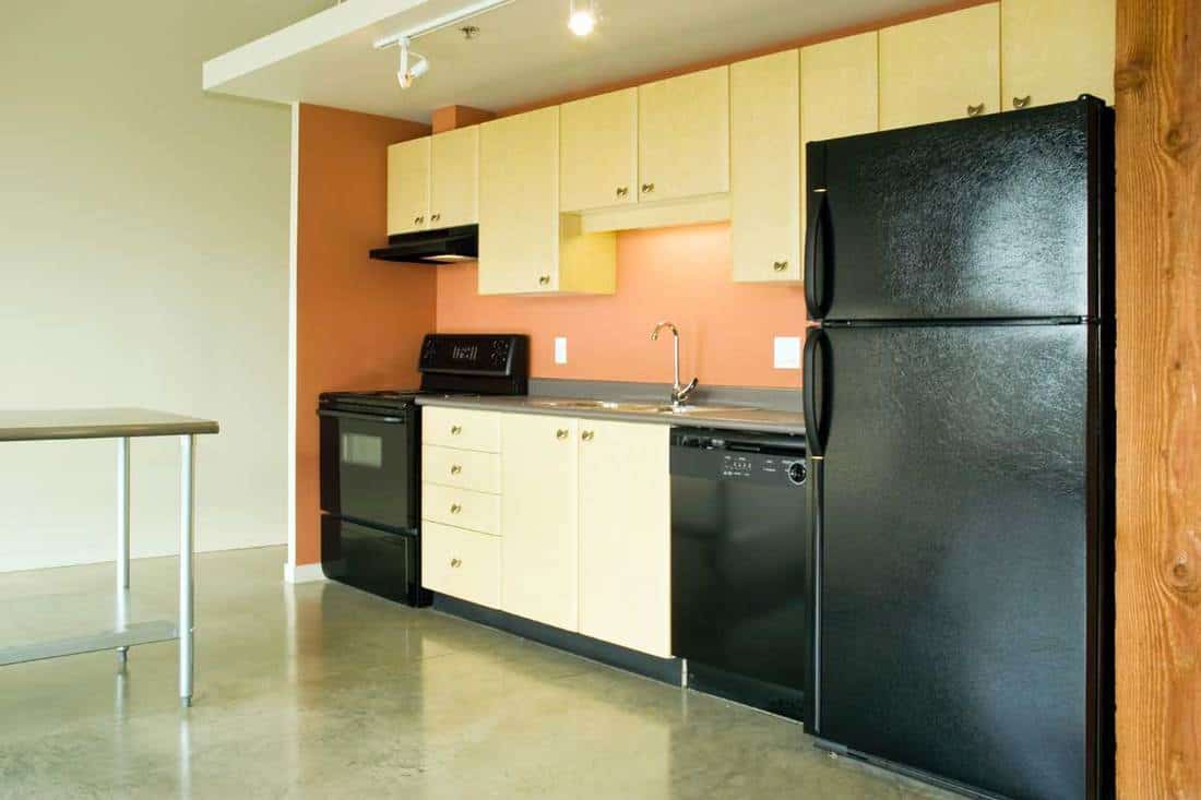This modern concrete condominium has an open-concept kitchen.
