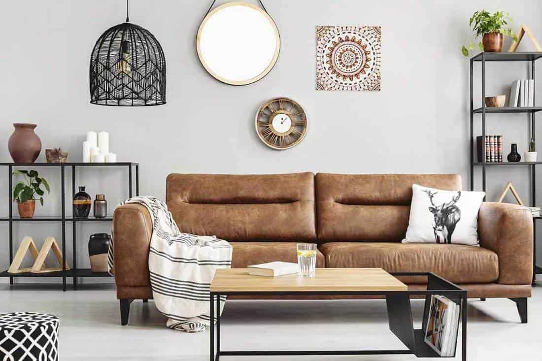Warm ethno living room with big comfortable leather couch and metal furniture, 24 Living Room Mirror Decorating Ideas [With Pictures]