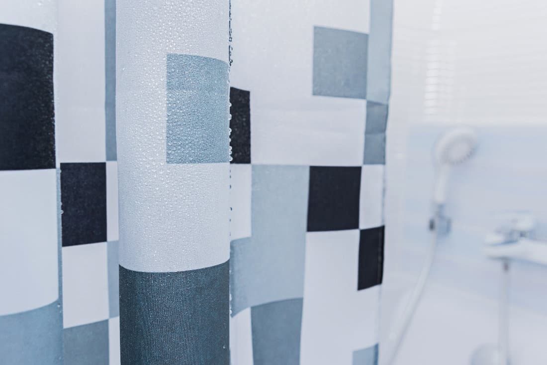 White bathroom with black and white shower curtain