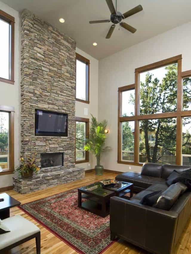 Living room with brown leather sofa, fireplace and brick wall