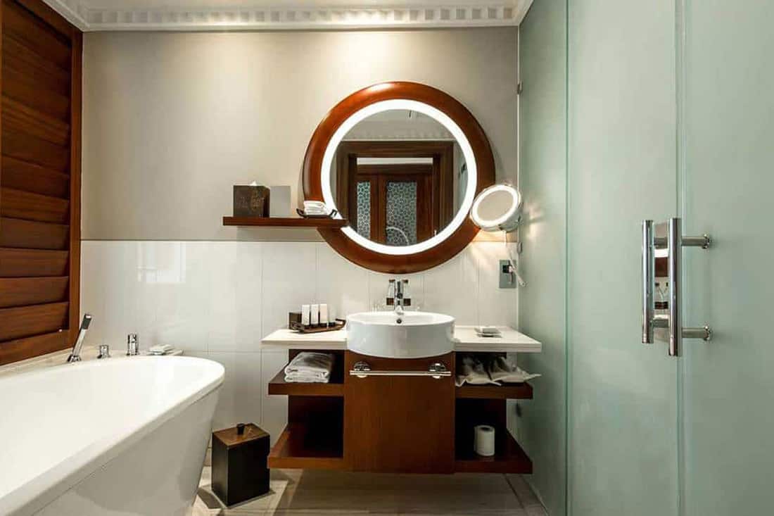 A modern bathroom suite with a nice large round mirror, 43 Bathroom Mirror Decorating Ideas