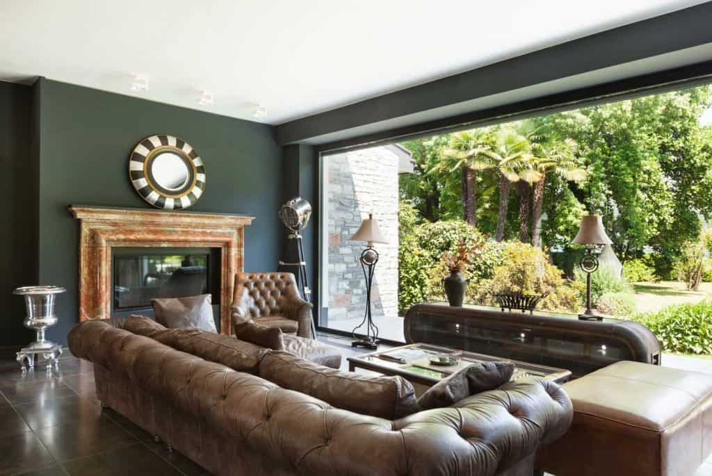 Dark Brown Leather Sofa in a beautiful living room overlooking a garden