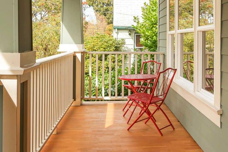 Front porch with parquet floor, red table and chairs, What Is the Best Flooring for a Porch?