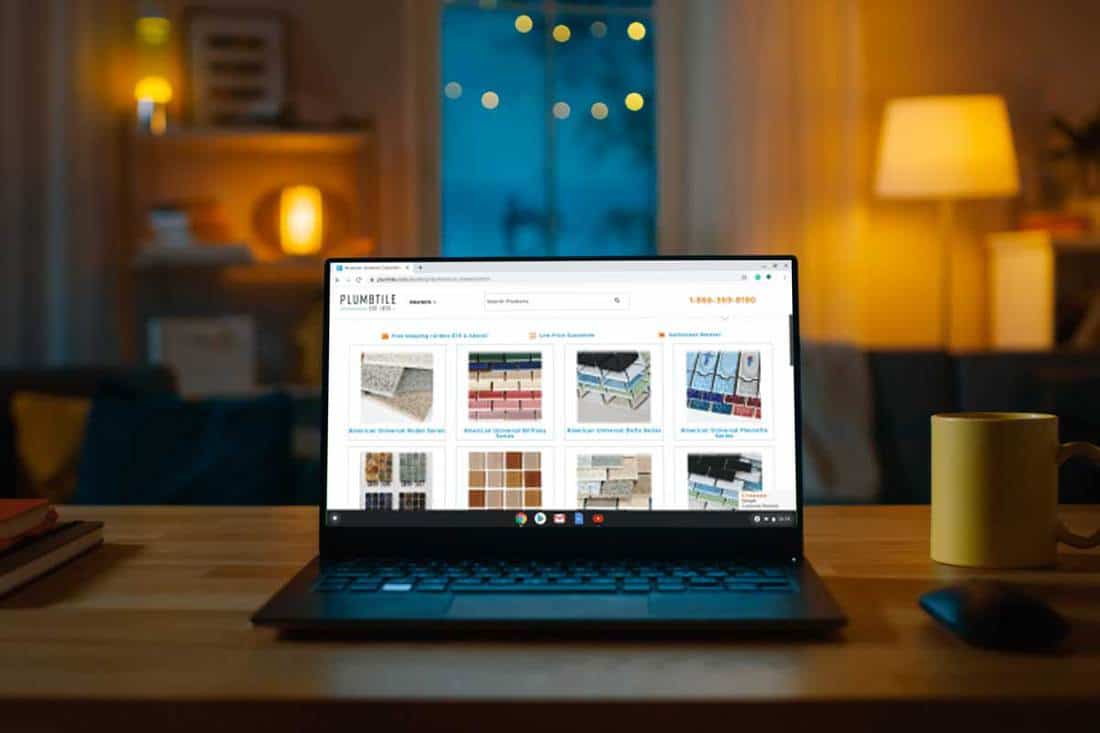 Laptop Computer Showing Bathroom tiles Online Stands on a Desk in the Living Room, Where to Buy Bathroom Tiles [30 Online Stores]