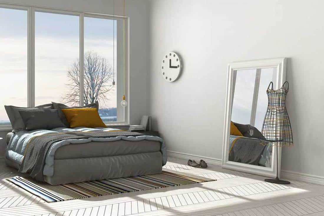 Modern white bedroom with floor mirror that has reflection of the room windows, 37 Floor Mirror Decorating Ideas