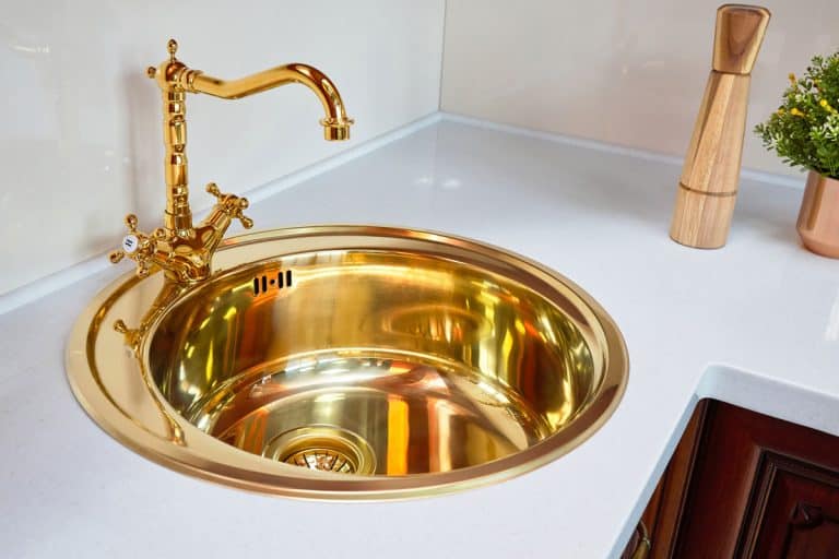 Polished shining brass kitchen faucet and white granite countertop, 10 Gorgeous Polished Brass Kitchen Faucets