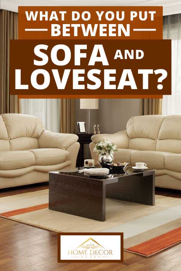 Modern living room with beige sofa set, coffee table and parquet floor, What Do You Put Between Sofa And Loveseat?