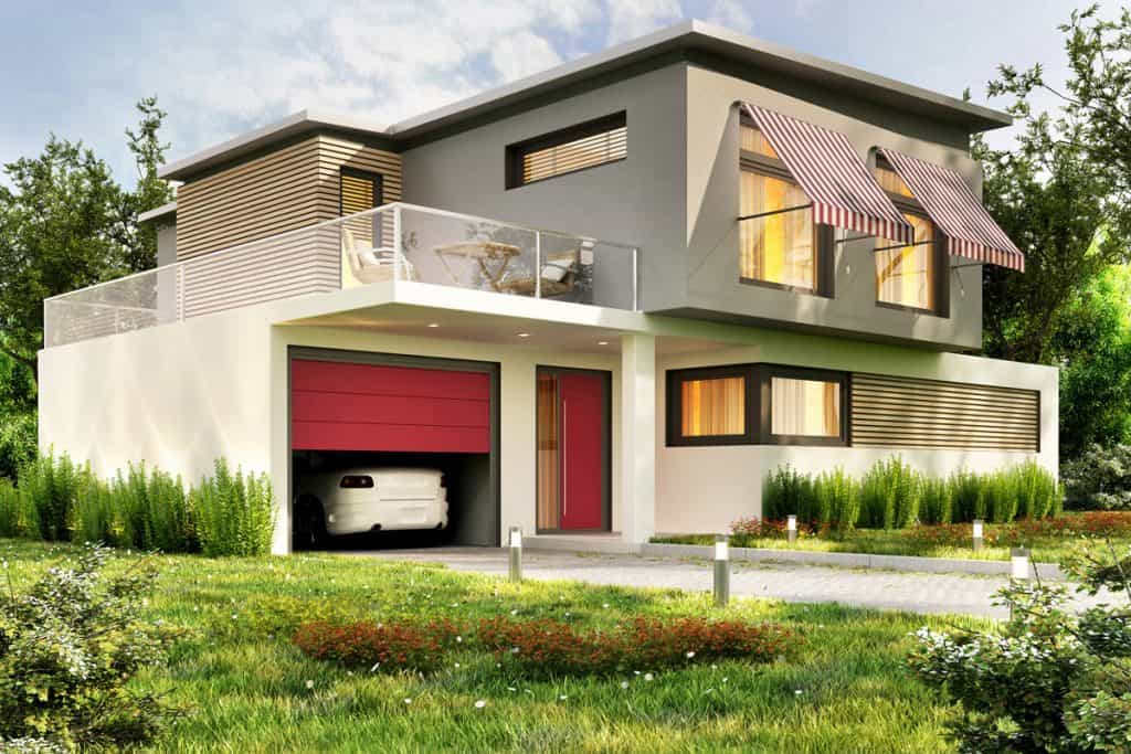 A modern luxurious house with a red front door, red garage door, and seamless windows