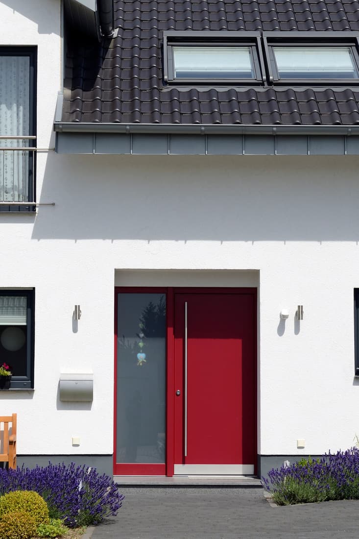 A modern two storey bungalow with a red aluminum door, and a one cargo garage