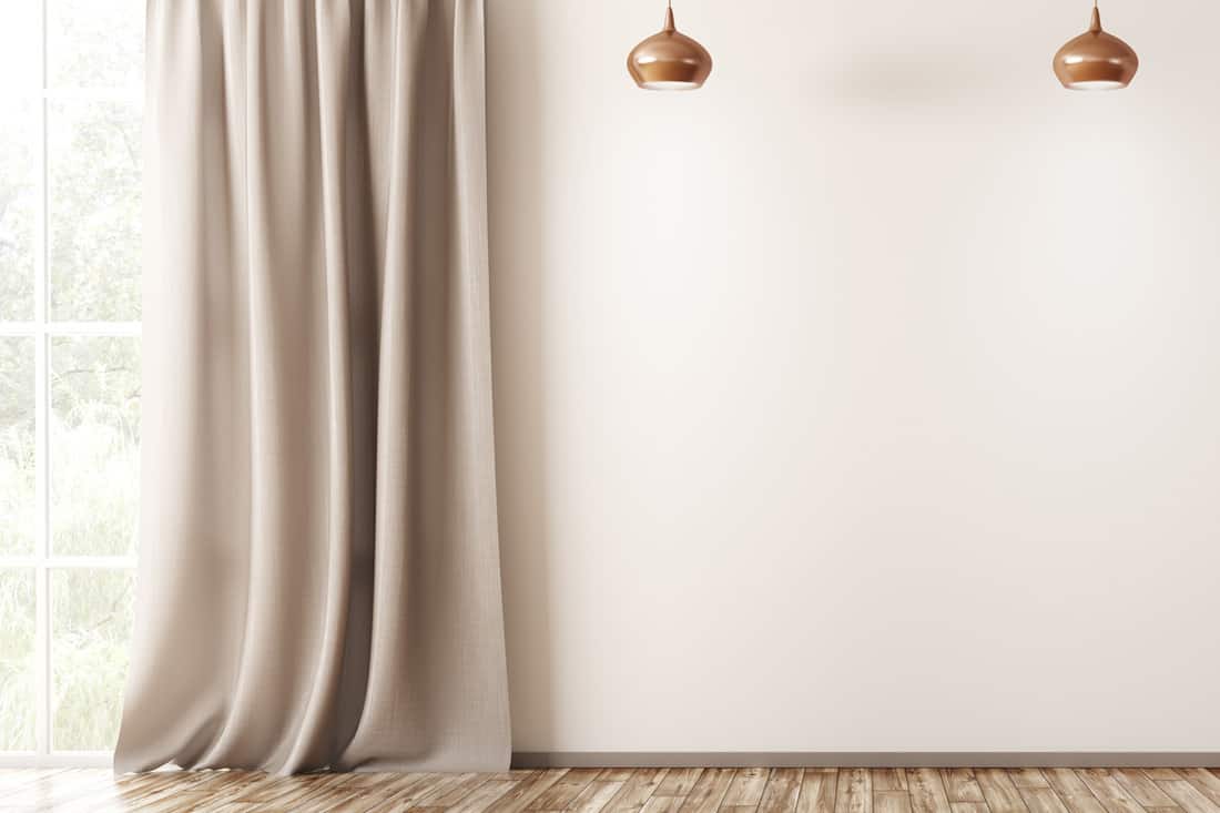 Beige colored walls with long light brown colored curtains