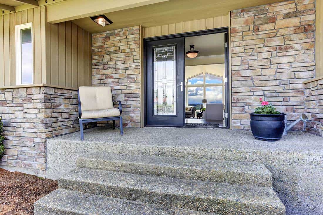 House entrance porch with stone wall trim