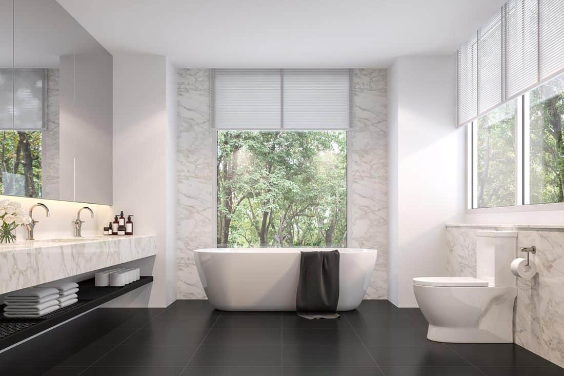 Luxurious bathroom with white walls, white bathtub, and dark tiled flooring, What is the Best Color For the Bathroom Floor?