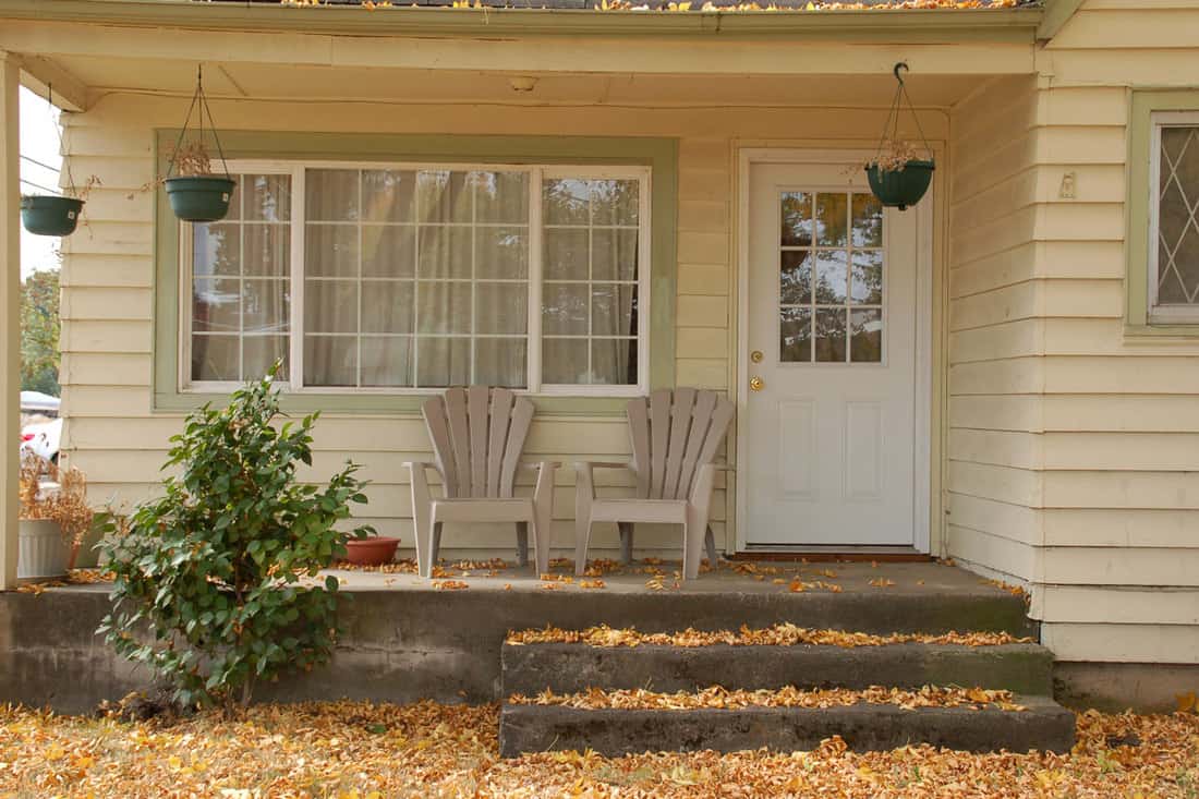 Old fashioned front porch with chairs on the front