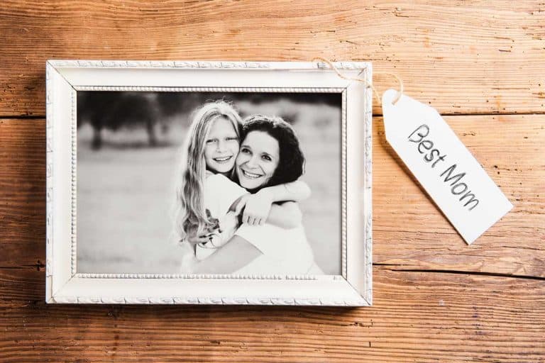 Photo of mother and daughter in picture frame shot on wooden background, 13 Awesome Picture Frame Gift Ideas For Mom