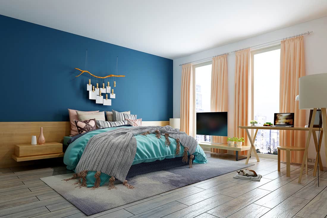 A bedroom with a blue and white colored wall and a peach colored curtain mixed with a sky blue bedding set, How To Choose Curtains For The Bedroom