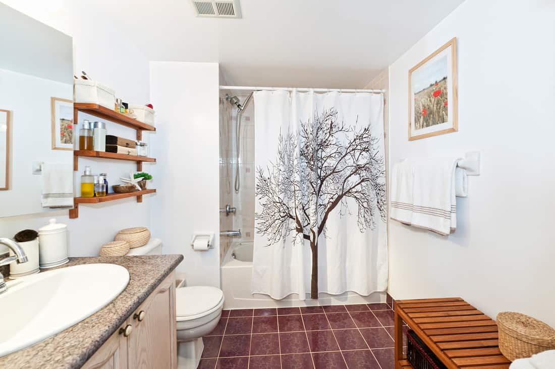 A modern bathroom with a white shower curtain and an old tree design on it, 9 Types of Shower Curtain Liners You Should Know