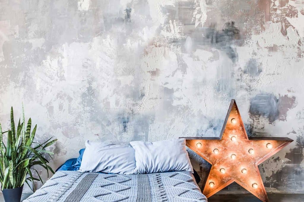 Grungy shabby wall in bedroom with star-shaped lamp