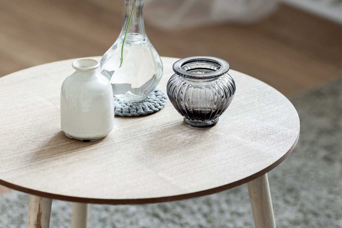 Home interior with scandinavian style wooden round coffee table, What To Put On A Coffee Table [6 GREAT Suggestions]