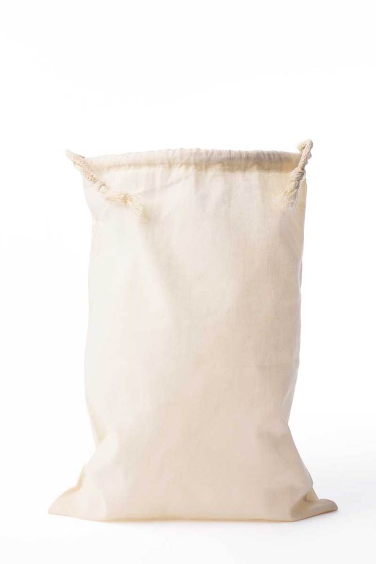 Isolated shot of cotton drawstring bag on white background