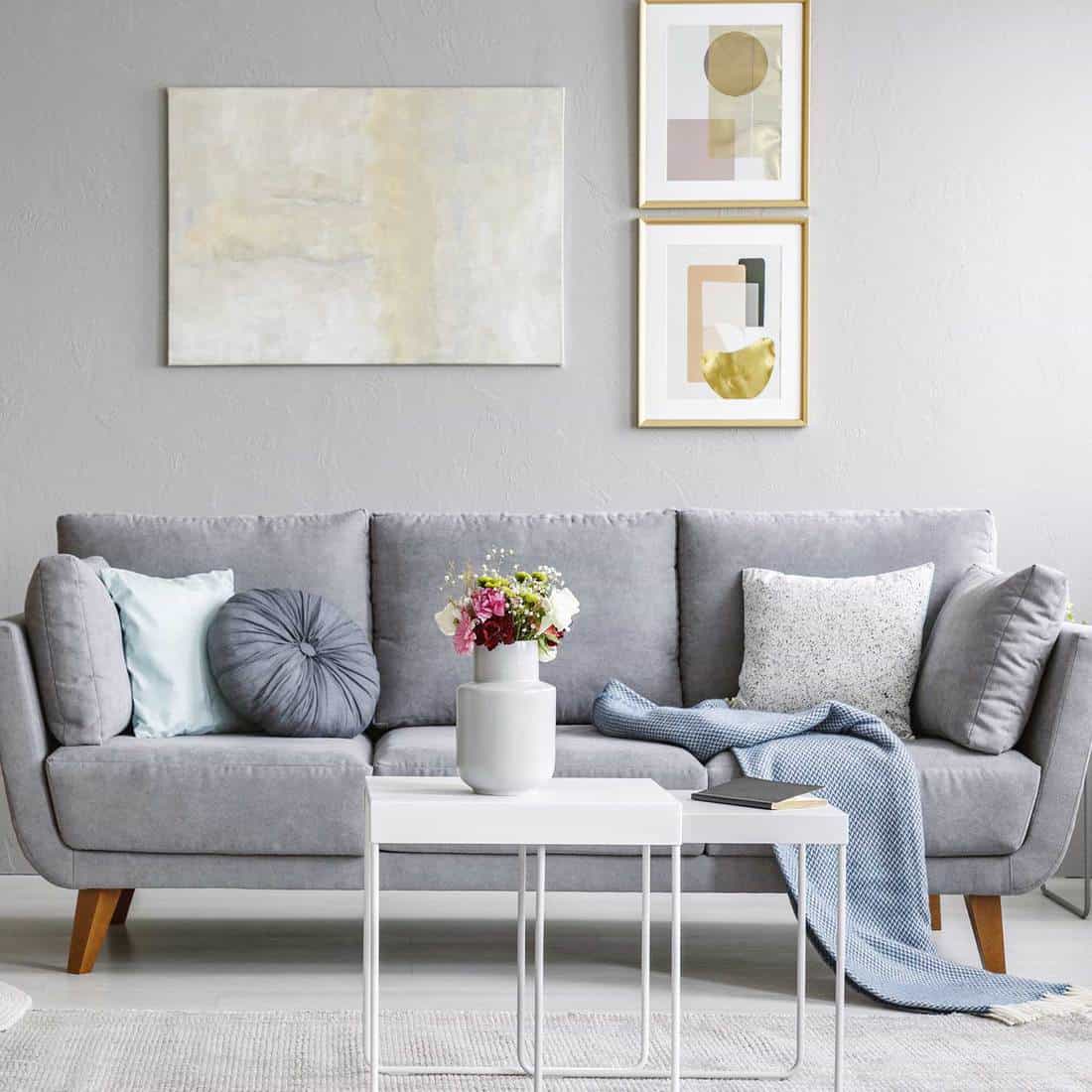 Living Room Interior With Grey Sofa And Flowers On Table 