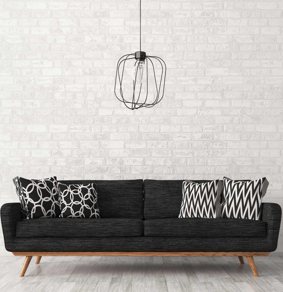 Modern interior of living room with black sofa and lamp against of white brick wall