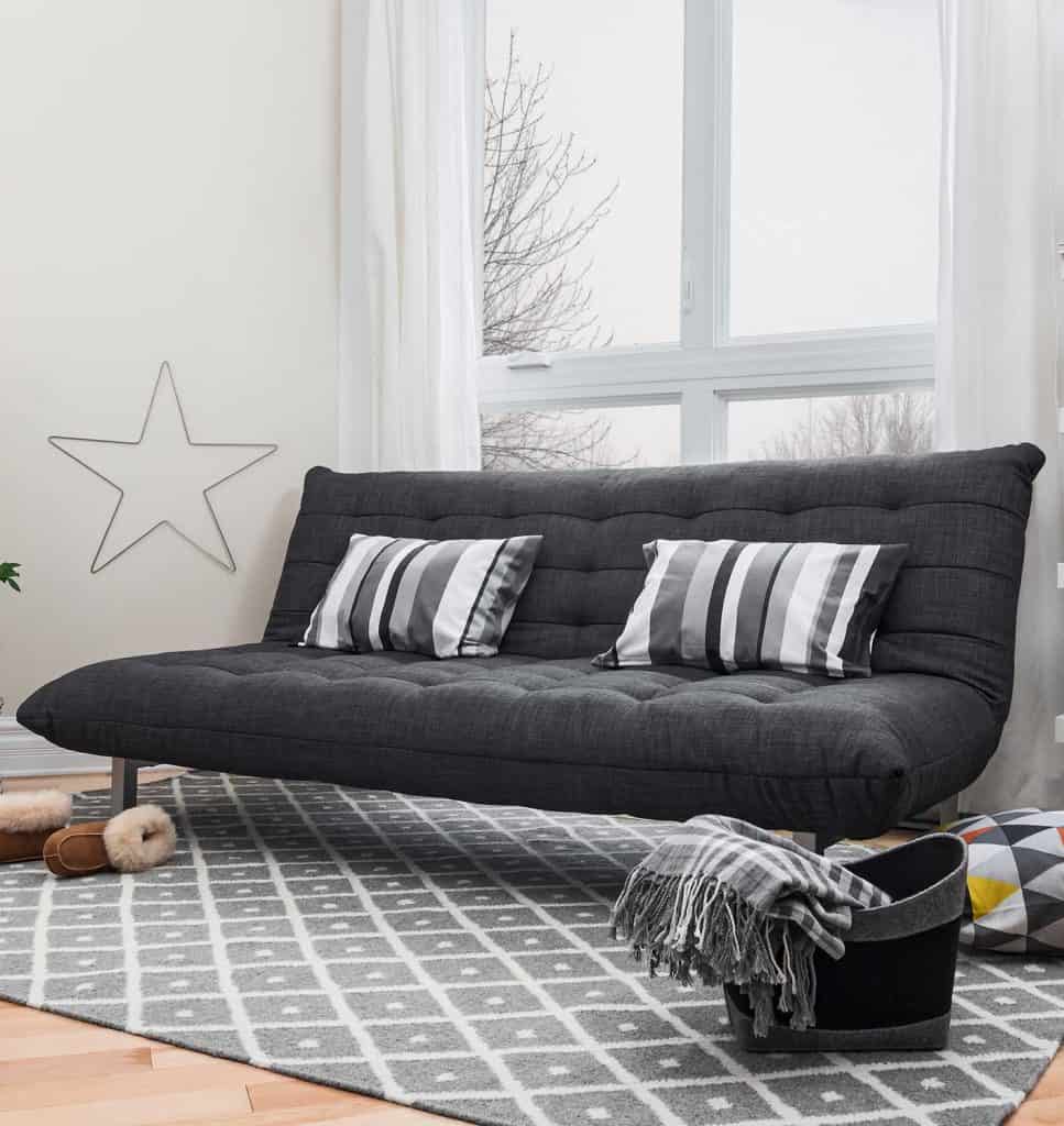 Spacious living room with dark grey sofa and modern decor