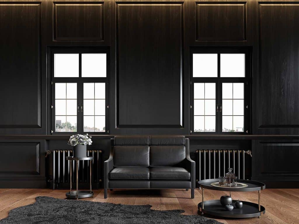 Black classic loft interior with wall panels, leather sofa, carpet and decor