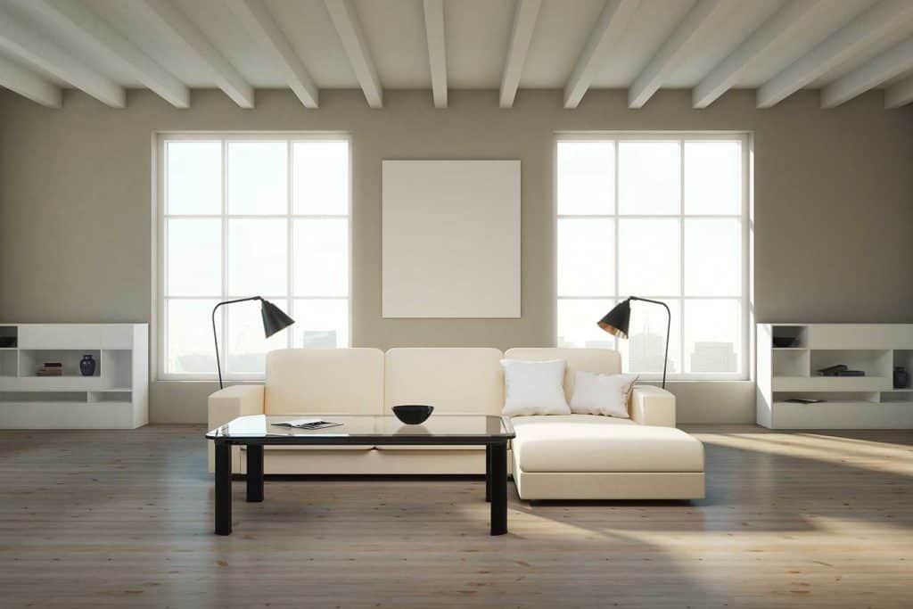 Modern living room with a white empty poster and an off-white sofa with a metal floor lamp on both sides
