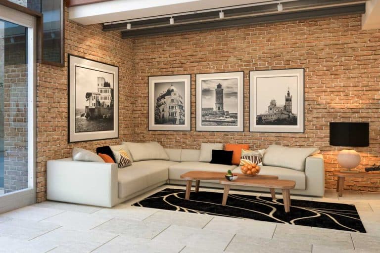 Modern loft apartment living room interior with posters on brick wall, How to Decorate a Large Wall in the Living Room [12 Actionable Ideas]