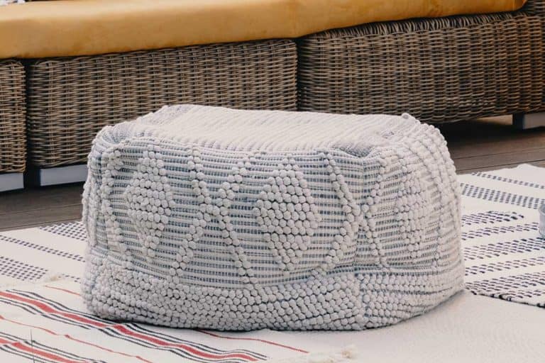 Pouf next to rattan couch on wooden terrace, How to clean an ottoman or pouf [Cleaning method by fabric type]