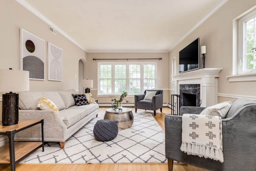 White patterned area rug matching the overall light gray sofa