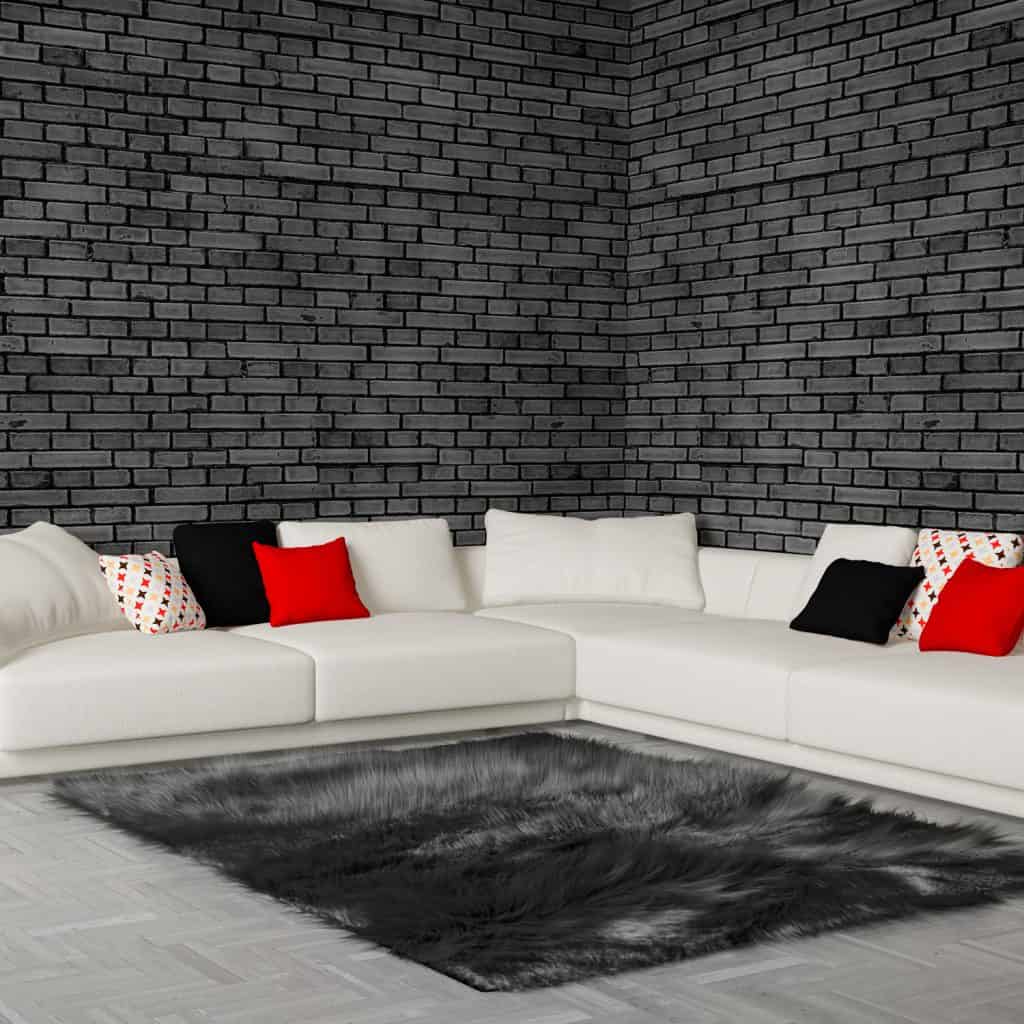 Stylish and cozy living room interior with big corner sofa, modern fireplace and dark gray fur rug