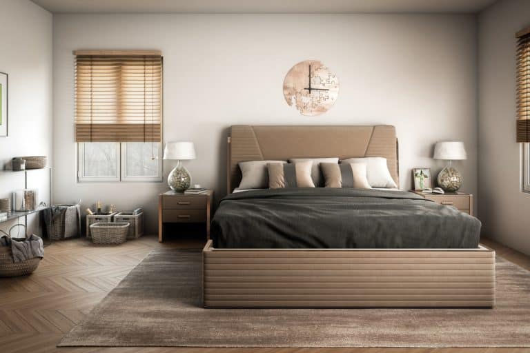 A brown themed bedroom with brown bedding sets and a light gray colored wall, How Big Should Wall Clock Be?