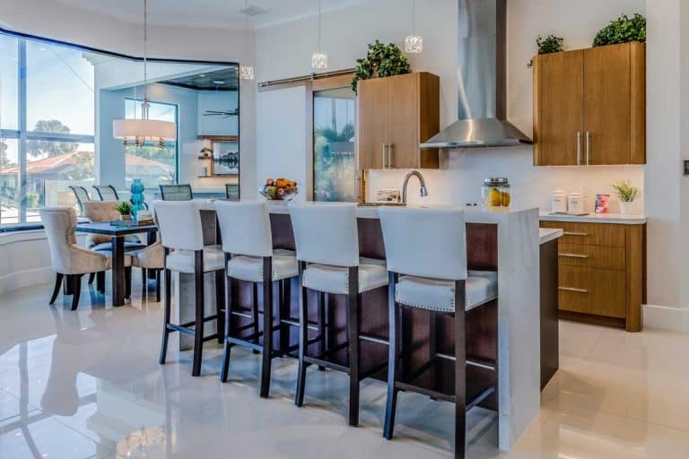 Amenities in new kitchen include pull down faucet and pendant lighting and dining chairs and bar stools, Should Your Bar Stools Match Your Dining Chairs?