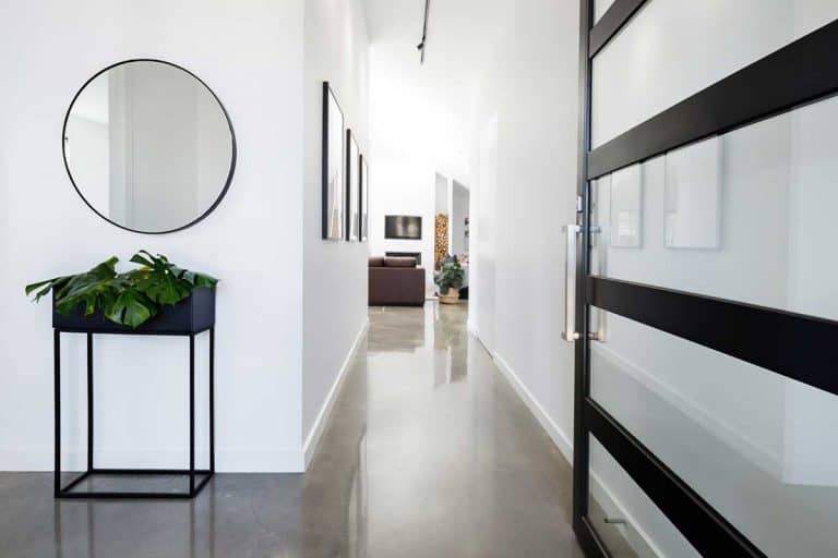 Contemporary home entry hall with polished concrete floors, Should An Entryway Have a Mirror (And How Big Should It Be)?