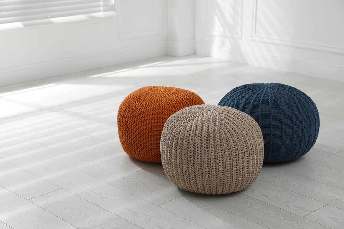 Different colored poufs inside a living room