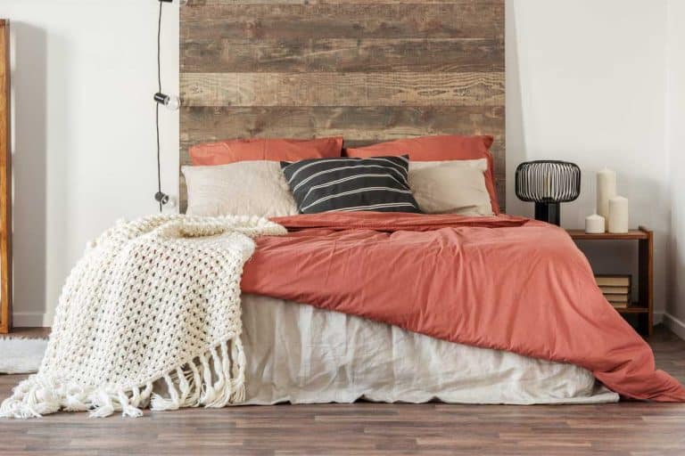 King size bed with wooden headboard in a beautiful bedroom interior, Can A King Size Bed Fit In A 12' By 12' Room?