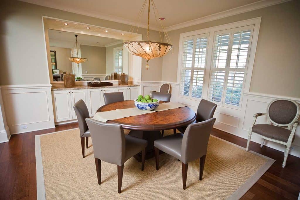 Modern dining room interior with round table and classy furniture