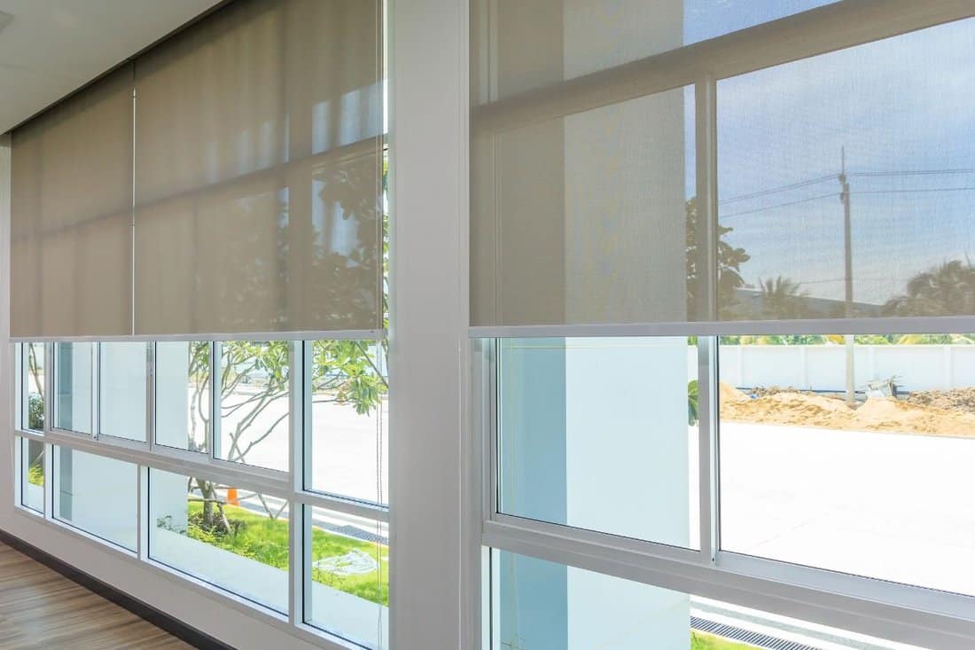 Roll Blinds on the windows, the sun does not penetrate the house. Window in the Interior Roller Blinds. Beautiful Blinds on the Window, the Sun an