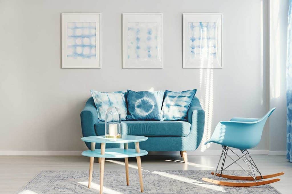 Simple blue living room interior with round coffee table