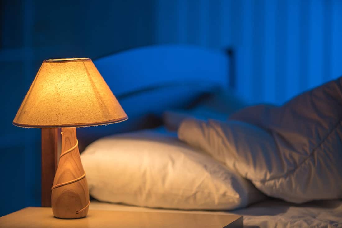 The lamp against the background of the bed