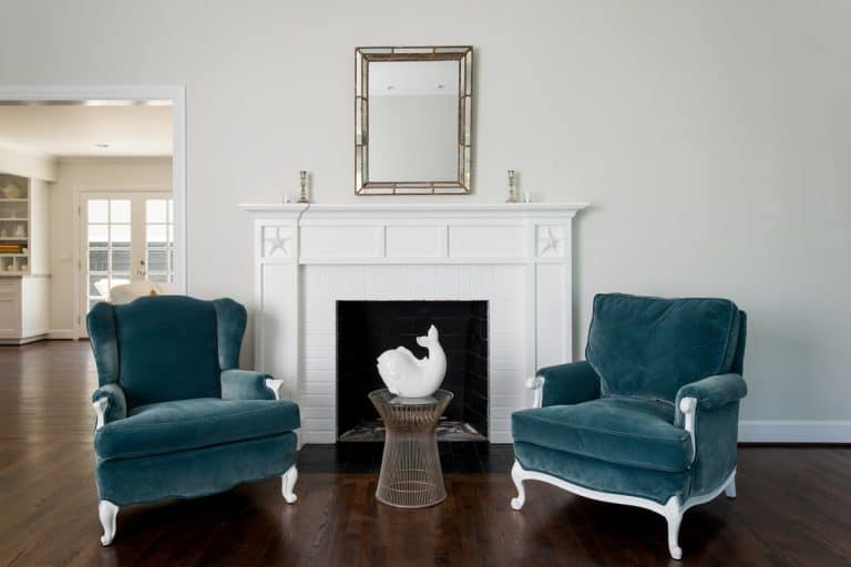 Two classic accent chairs and a white colored fireplace mantel, What Color Should My Fireplace Mantel Be? [3 Design Options]