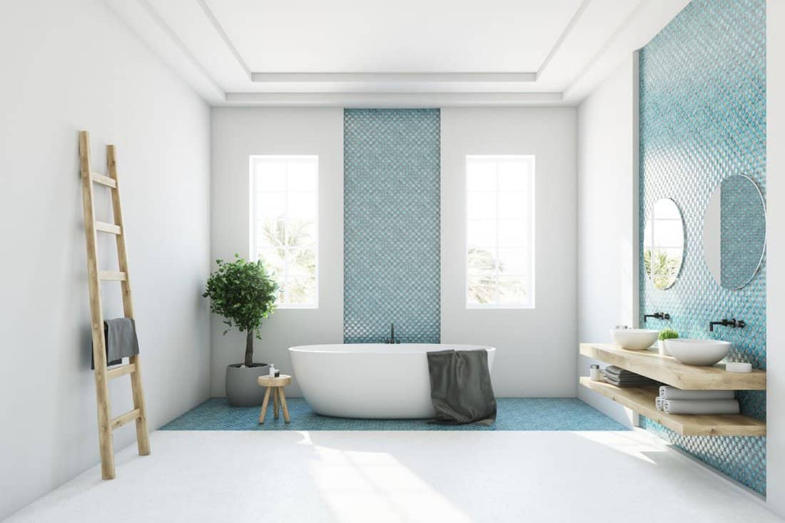 White and blue bathroom interior with a round white tub, two narrow windows, a tree in a pot and a ladder in a corner. Side view. 3d rendering mock up 