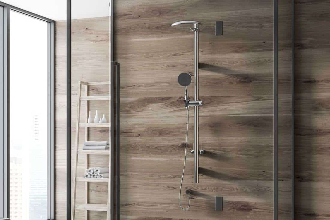 Wooden wall bathroom corner with a concrete floor, Are Shower Panels Better Than Tiles?