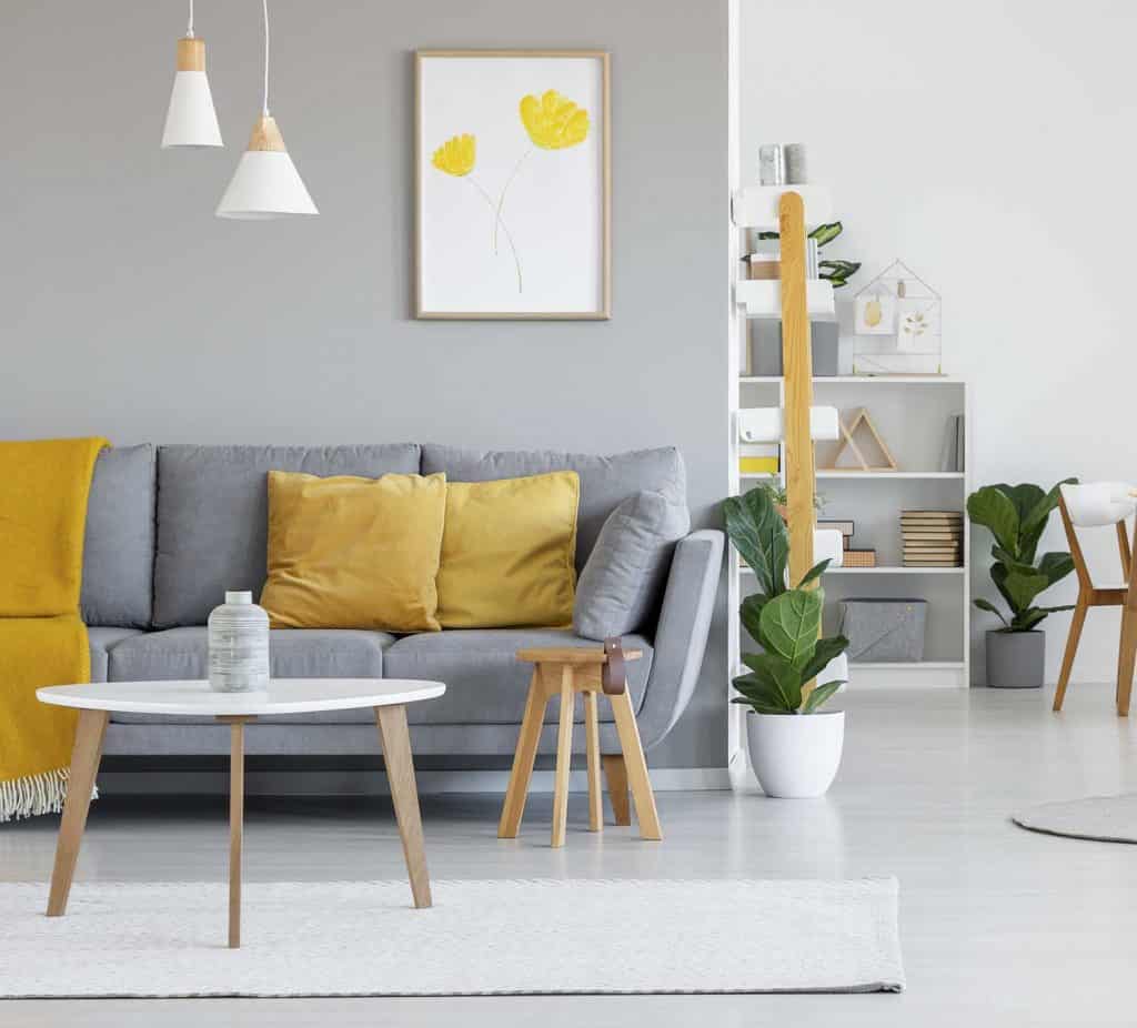 Yellow cushions and blanket on gray sofa in the living area