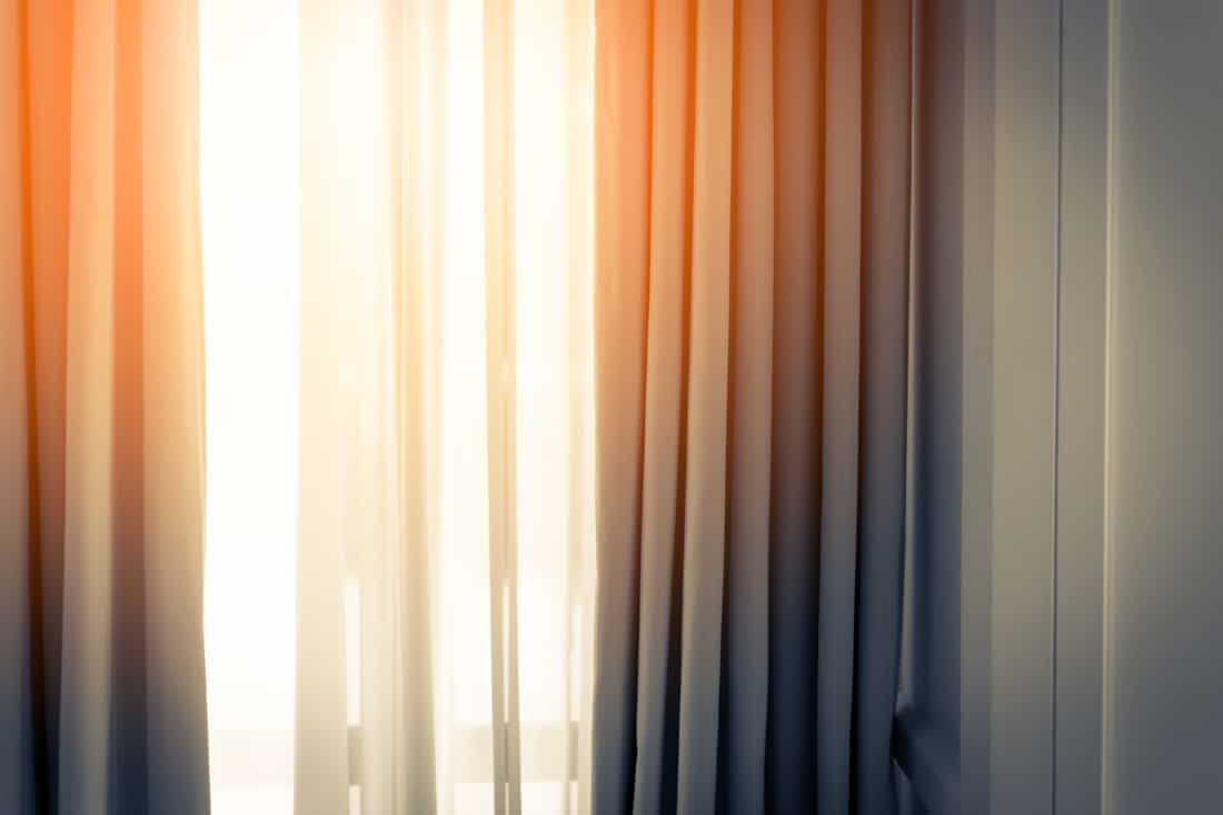 A brown curtain facing the living room and properly lit by the sun