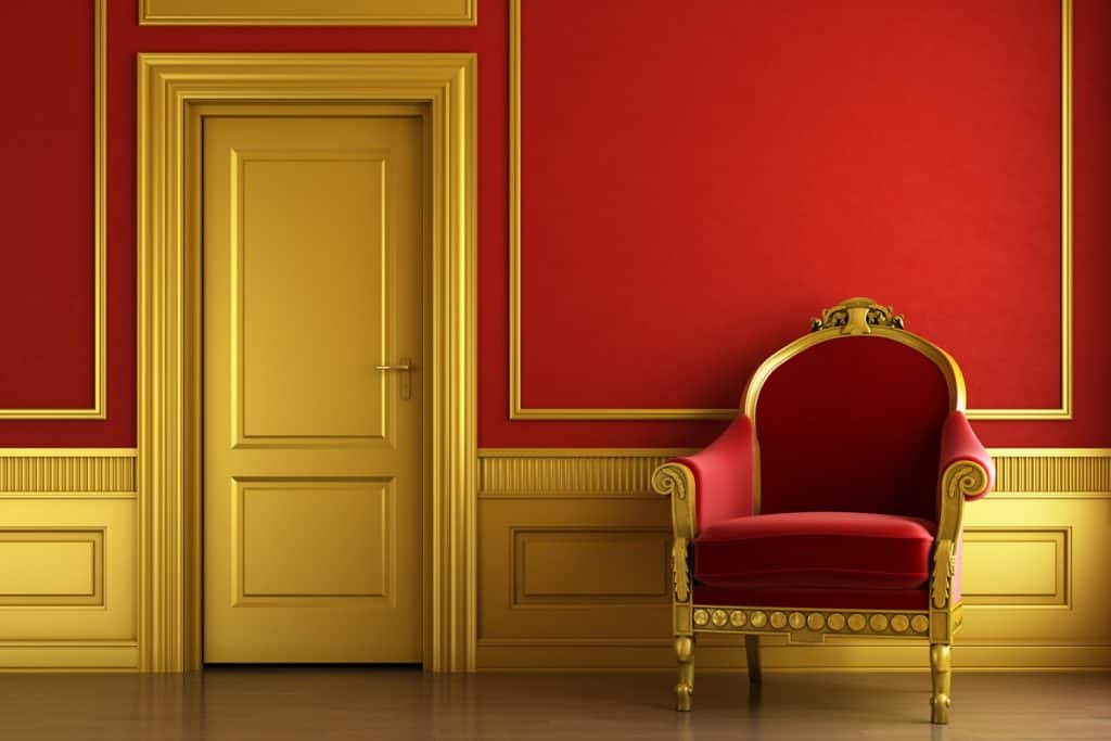 A golden door with gold framing and a gold baseboard